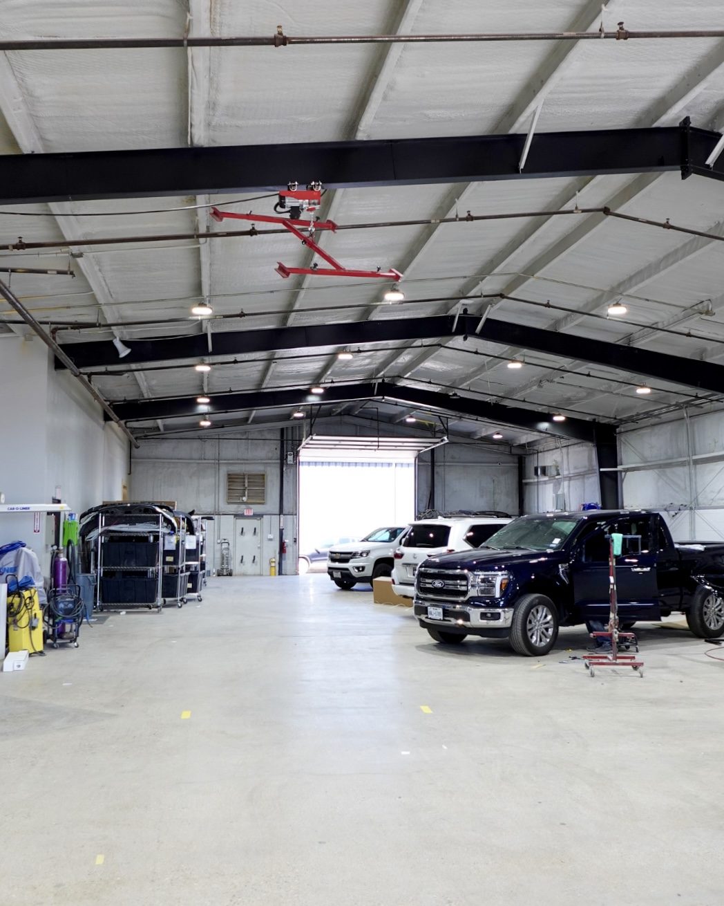 Clean, organized repair bays inside a Renew Collision West Texas shop